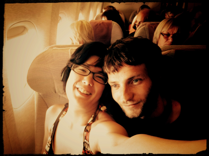 Lifelong Vagabonds' airplane selfie photobombed by a creeping passenger